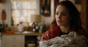 Movie still from “The Family Stone” (2005), directed by Thomas Bezucha – A woman sitting in a living room holding a blanket; Close Up shot, Over the shoulder angle