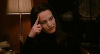 Movie still from “The Family Stone” (2005), directed by Thomas Bezucha – A woman with dark brown hair is holding her hand up to her head; Close Up shot, High angle