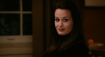Movie still from “The Family Stone” (2005), directed by Thomas Bezucha – A woman with long dark brown hair wearing a black shirt; Close Up shot, Over the shoulder angle