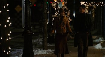 Movie still from “The Family Stone” (2005), directed by Thomas Bezucha – A woman walking down a street at night; Medium shot, Over the shoulder angle