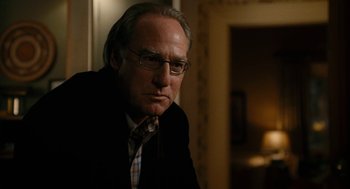 Movie still from “The Family Stone” (2005), directed by Thomas Bezucha – An older man wearing a suit and tie; Close Up shot, Over the shoulder angle