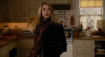 Movie still from “The Family Stone” (2005), directed by Thomas Bezucha – A woman standing in a kitchen wearing a scarf; Medium shot, Over the shoulder angle