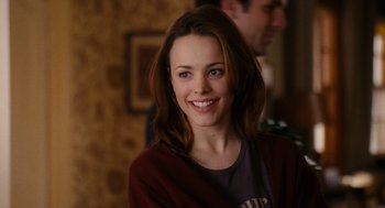 Movie still from “The Family Stone” (2005), directed by Thomas Bezucha – A woman smiles for the camera while wearing a sweater; Close Up shot, Over the shoulder angle
