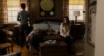 Movie still from “The Family Stone” (2005), directed by Thomas Bezucha – A woman sitting on a couch in a living room; Wide shot, High angle