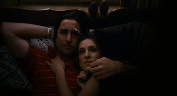 Movie still from “The Family Stone” (2005), directed by Thomas Bezucha – A man and a woman sitting on a couch together; Close Up shot, Overhead angle