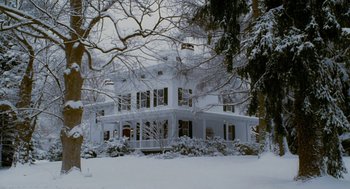 Movie still from “The Family Stone” (2005), directed by Thomas Bezucha – A large white house in the middle of a snow covered forest; Extreme Wide shot, Low angle
