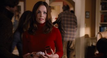Movie still from “The Family Stone” (2005), directed by Thomas Bezucha – A woman in a red sweater holding a box of chocolates; Close Up shot, Over the shoulder angle
