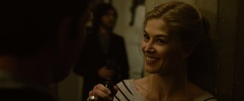 Movie still from “Gone Girl” (2014), directed by David Fincher – A woman smiling while holding a glass of wine; Close Up shot, Over the shoulder angle