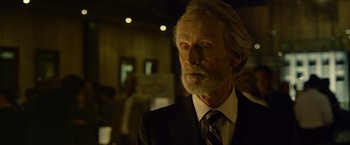 Movie still from “Gone Girl” (2014), directed by David Fincher – An older man in a black suit and a white beard; Close Up shot, Low angle