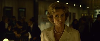 Movie still from “Gone Girl” (2014), directed by David Fincher – An older woman wearing a white jacket and a pearl necklace; Close Up shot, Low angle