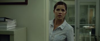 Movie still from “Gone Girl” (2014), directed by David Fincher – A woman standing in front of a wall looking at the camera; Close Up shot, Over the shoulder angle