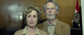 Movie still from “Gone Girl” (2014), directed by David Fincher – An older man and a younger woman standing next to each other; Close Up shot, Low angle