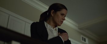 Movie still from “Gone Girl” (2014), directed by David Fincher – A woman in a black jacket and white shirt; Close Up shot, Low angle