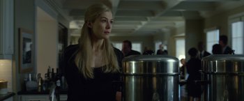 Movie still from “Gone Girl” (2014), directed by David Fincher – A woman standing next to a large metal container; Medium shot, Low angle