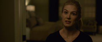 Movie still from “Gone Girl” (2014), directed by David Fincher – A beautiful blond haired woman in a black shirt; Close Up shot, Over the shoulder angle