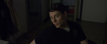 Movie still from “Gone Girl” (2014), directed by David Fincher – A person wearing a black shirt; Close Up shot, Over the shoulder angle