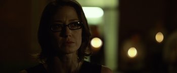 Movie still from “Gone Girl” (2014), directed by David Fincher – A person wearing glasses and a black shirt; Close Up shot, Over the shoulder angle