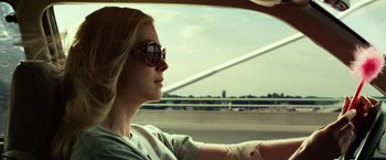 Movie still from “Gone Girl” (2014), directed by David Fincher – A woman sitting in the driver's seat of a car looking out the window; Close Up shot, Low angle
