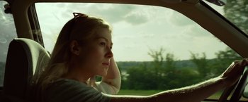 Movie still from “Gone Girl” (2014), directed by David Fincher – A woman sitting in a car looking out the window; Close Up shot, Low angle