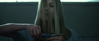 Movie still from “Gone Girl” (2014), directed by David Fincher – A woman cutting her long hair with a pair of scissors; Close Up shot, Over the shoulder angle