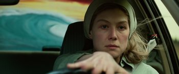 Movie still from “Gone Girl” (2014), directed by David Fincher – A woman sitting in a car with her hand resting on the steering wheel; Close Up shot, High angle