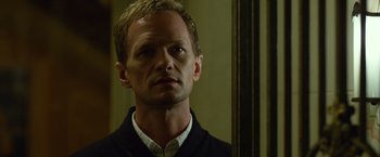 Movie still from “Gone Girl” (2014), directed by David Fincher – A man standing in front of a mirror; Close Up shot, Over the shoulder angle