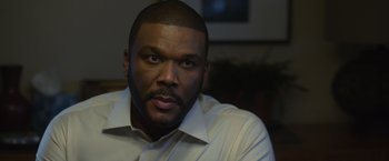 Movie still from “Gone Girl” (2014), directed by David Fincher – A person wearing a white shirt; Close Up shot, Over the shoulder angle