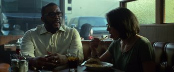 Movie still from “Gone Girl” (2014), directed by David Fincher – A man and a woman sitting at a table; Medium shot, Over the shoulder angle