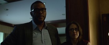 Movie still from “Gone Girl” (2014), directed by David Fincher – A man and a woman standing next to each other; Medium shot, Low angle