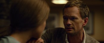 Movie still from “Gone Girl” (2014), directed by David Fincher – A man and a woman sitting in front of each other in a room; Close Up shot, Over the shoulder angle