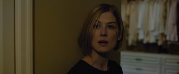 Movie still from “Gone Girl” (2014), directed by David Fincher – A person with short blonde hair; Close Up shot, Over the shoulder angle