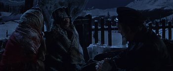 Movie still from “The Fearless Vampire Killers” (1967), directed by Roman Polanski – Two people sitting on a bench in the snow at night; Medium shot, Over the shoulder angle