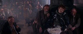 Movie still from “The Fearless Vampire Killers” (1967), directed by Roman Polanski – A group of men sitting around a cake; Wide shot, High angle