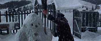 Movie still from “The Fearless Vampire Killers” (1967), directed by Roman Polanski – A person holding a broom near a snowman; Medium shot, Low angle