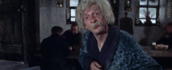 Movie still from “The Fearless Vampire Killers” (1967), directed by Roman Polanski – An old man with a white beard is posing for a picture; Close Up shot, Over the shoulder angle