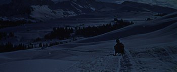 Movie still from “The Fearless Vampire Killers” (1967), directed by Roman Polanski – A person riding a horse drawn carriage on a snowy slope; Extreme Wide shot, High angle