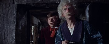 Movie still from “The Fearless Vampire Killers” (1967), directed by Roman Polanski – A man and a woman standing next to each other in a room; Close Up shot, Low angle