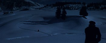 Movie still from “The Fearless Vampire Killers” (1967), directed by Roman Polanski – A person is skiing in the snow at night; Extreme Wide shot, High angle