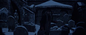 Movie still from “The Fearless Vampire Killers” (1967), directed by Roman Polanski – An old man standing in the snow next to a stone wall; Wide shot, Low angle