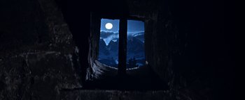 Movie still from “The Fearless Vampire Killers” (1967), directed by Roman Polanski – A view from inside a cave looking out at a full moon; Wide shot, Low angle