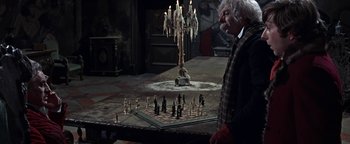 Movie still from “The Fearless Vampire Killers” (1967), directed by Roman Polanski – An old man standing in front of a chess board; Medium shot, High angle