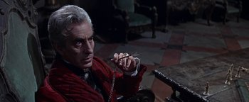 Movie still from “The Fearless Vampire Killers” (1967), directed by Roman Polanski – An older man holding a pair of scissors in his hand; Medium shot, Over the shoulder angle