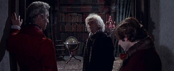 Movie still from “The Fearless Vampire Killers” (1967), directed by Roman Polanski – A man in a black jacket standing in a library; Medium shot, Over the shoulder angle