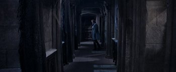 Movie still from “The Fearless Vampire Killers” (1967), directed by Roman Polanski – A man in a blue coat walking in a dark hallway; Wide shot, High angle