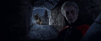 Movie still from “The Fearless Vampire Killers” (1967), directed by Roman Polanski – An old man looking into a cave with a goat in the background; Medium shot, Low angle