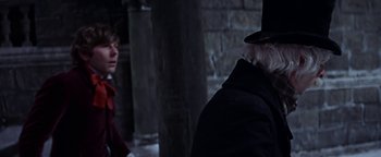 Movie still from “The Fearless Vampire Killers” (1967), directed by Roman Polanski – A man in a top hat and a woman in a red coat; Close Up shot, Over the shoulder angle