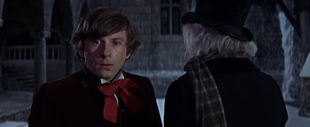 Movie still from “The Fearless Vampire Killers” (1967), directed by Roman Polanski – A man wearing a red bow tie standing next to another man wearing a hat; Close Up shot, Over the shoulder angle