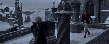 Movie still from “The Fearless Vampire Killers” (1967), directed by Roman Polanski – An old woman standing next to a statue in the middle of a snowy field; Wide shot, Low angle