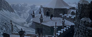 Movie still from “The Fearless Vampire Killers” (1967), directed by Roman Polanski – A person standing on top of a snow covered building; Extreme Wide shot, High angle