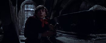 Movie still from “The Fearless Vampire Killers” (1967), directed by Roman Polanski – A young man holding a banana in a dimly - lit room; Medium shot, Low angle